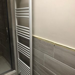 Grey & brown bathroom installation towel radiator.
