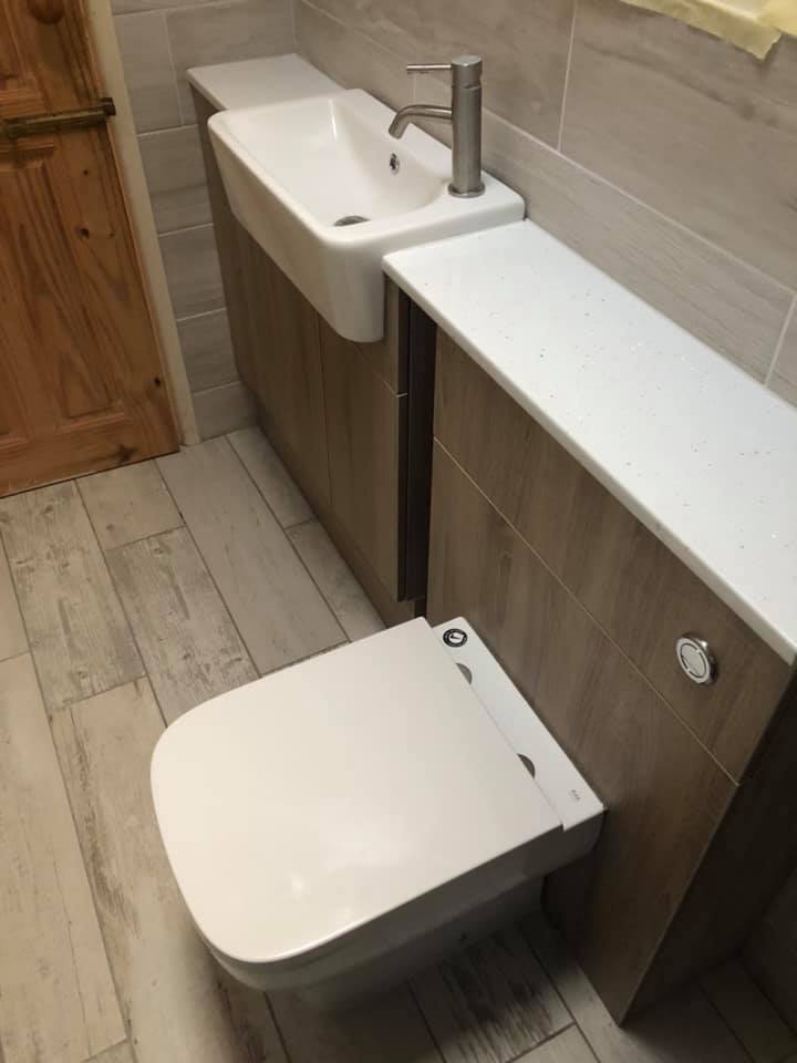 Grey & brown bathroom installation toilet and basin.
